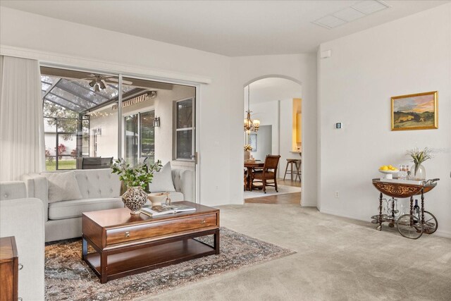 carpeted living room featuring visible vents and arched walkways