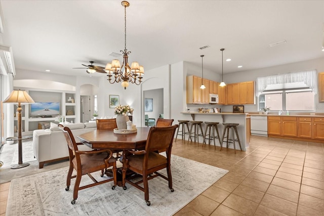 dining room with light tile patterned floors, visible vents, arched walkways, a notable chandelier, and recessed lighting