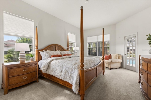 bedroom featuring light carpet and access to exterior