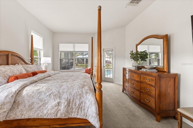 bedroom with light carpet, access to outside, multiple windows, and visible vents