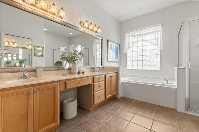 full bath with a garden tub, a sink, a shower stall, and double vanity