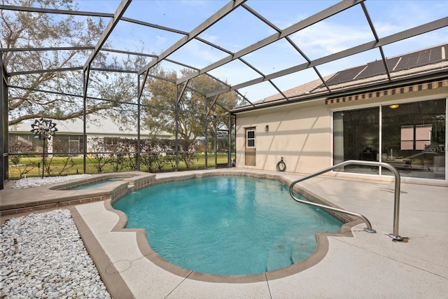 view of swimming pool featuring a patio, a lanai, and a pool with connected hot tub