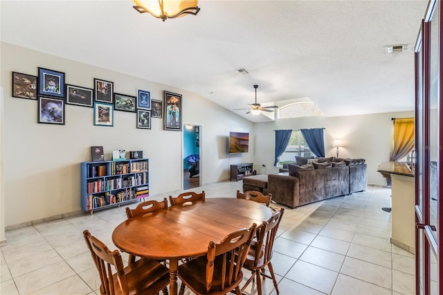 dining room featuring vaulted ceiling, ceiling fan, light tile patterned floors, and visible vents