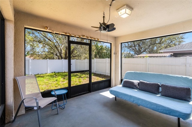 sunroom featuring ceiling fan