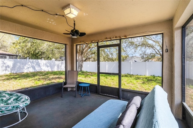 sunroom / solarium featuring ceiling fan