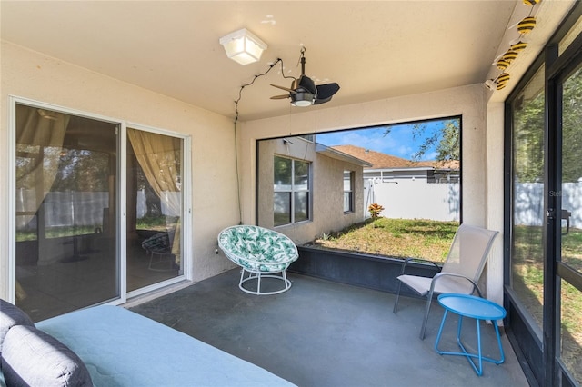 sunroom featuring ceiling fan