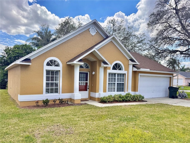 view of front facade featuring a garage, driveway, a front yard, and stucco siding