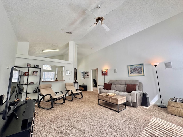 living area with a ceiling fan, a textured ceiling, visible vents, and carpet flooring