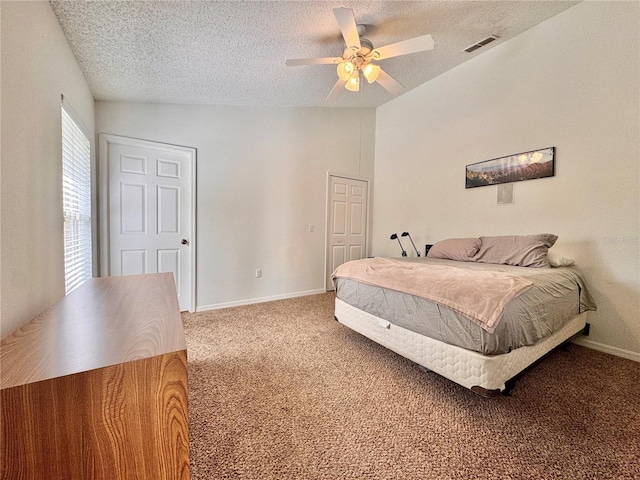 bedroom featuring baseboards, visible vents, lofted ceiling, a textured ceiling, and carpet flooring