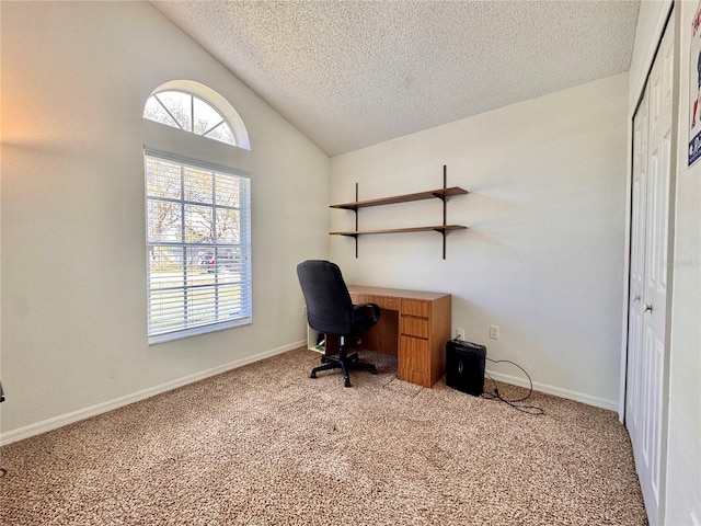 carpeted office space featuring lofted ceiling, a textured ceiling, and baseboards