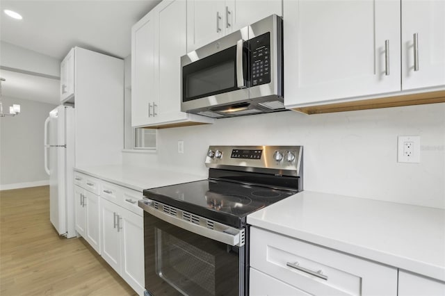 kitchen with white cabinetry, appliances with stainless steel finishes, and light countertops