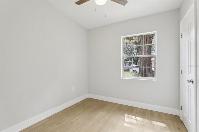 unfurnished room featuring light wood-type flooring, a wealth of natural light, and baseboards