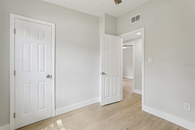 unfurnished bedroom featuring light wood-type flooring, visible vents, and baseboards