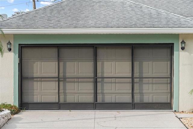 garage featuring concrete driveway