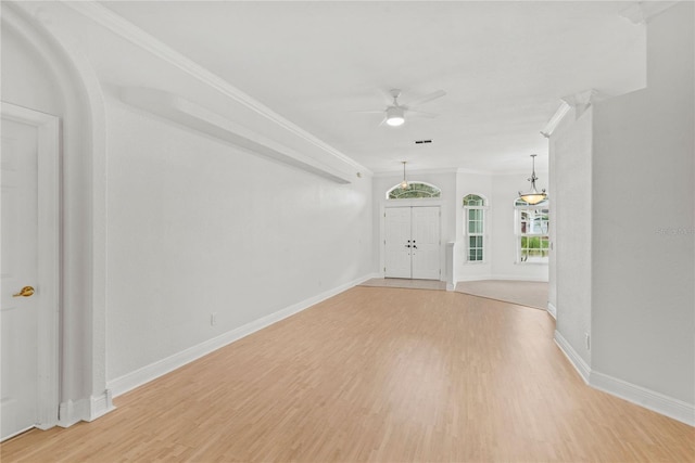 foyer featuring visible vents, ornamental molding, ceiling fan, light wood-type flooring, and baseboards