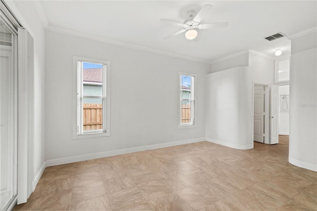 empty room with baseboards, visible vents, a ceiling fan, and ornamental molding