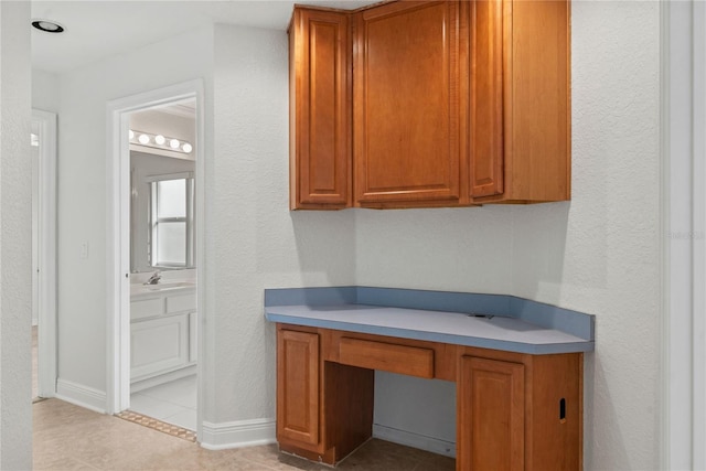 bathroom featuring tile patterned floors, vanity, and baseboards