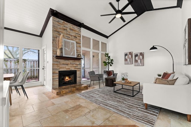 living room with high vaulted ceiling, a fireplace, ornamental molding, and ceiling fan