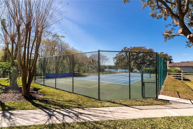 view of tennis court with fence