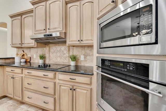 kitchen with light brown cabinetry, tasteful backsplash, under cabinet range hood, and stainless steel appliances