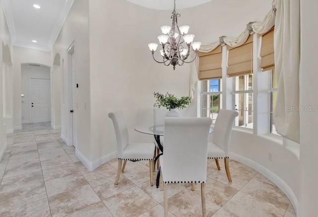 dining space featuring baseboards, ornamental molding, light tile patterned floors, arched walkways, and a notable chandelier