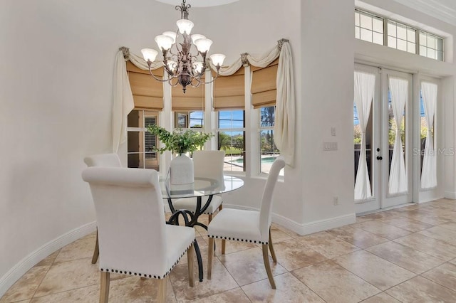 tiled dining space featuring an inviting chandelier, french doors, and baseboards