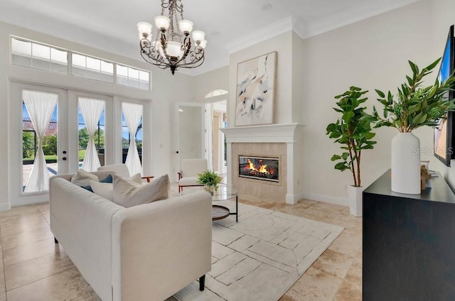 living area with a wealth of natural light, baseboards, crown molding, and a tile fireplace