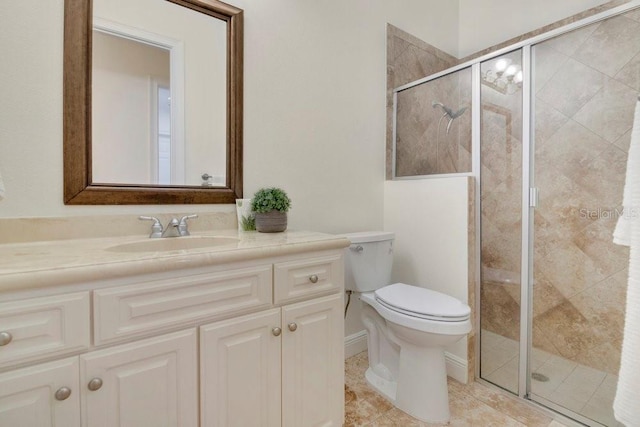 full bathroom with vanity, toilet, and a shower stall