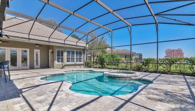 view of pool featuring a pool with connected hot tub, a lanai, a ceiling fan, and a patio area