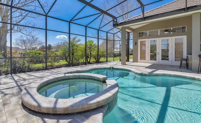 view of swimming pool featuring a ceiling fan, a pool with connected hot tub, french doors, glass enclosure, and a patio area