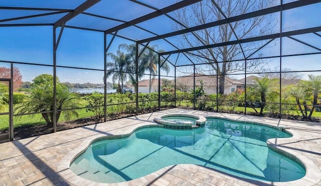 view of pool with a lanai, a pool with connected hot tub, a patio, and a water view