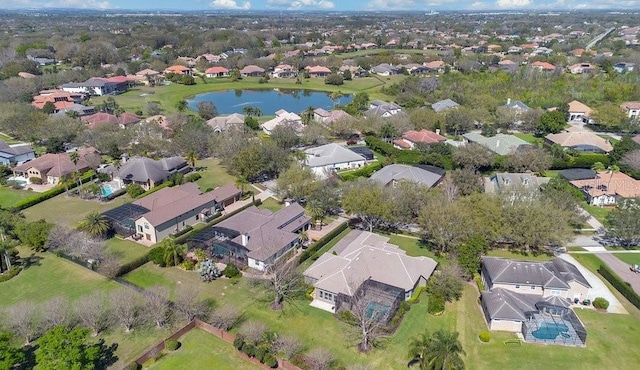 drone / aerial view with a residential view and a water view