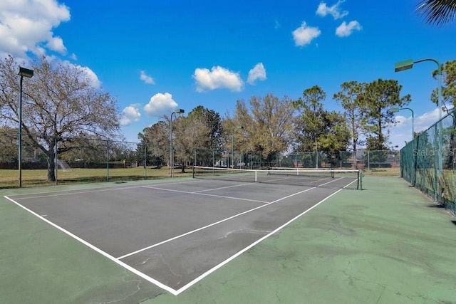 view of tennis court with fence