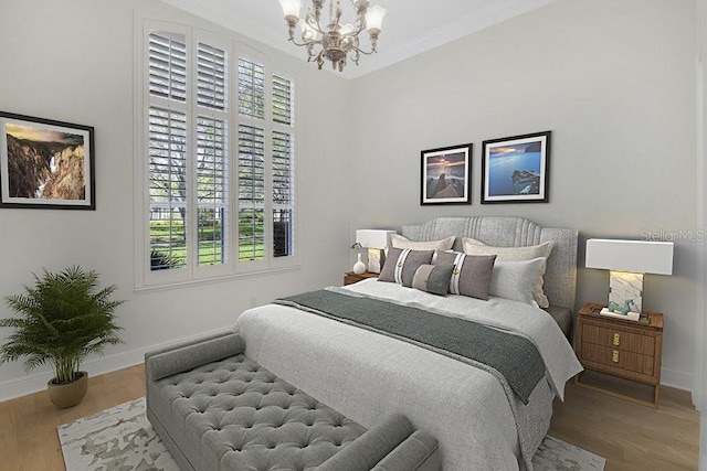 bedroom featuring baseboards, a notable chandelier, wood finished floors, and ornamental molding