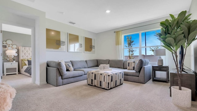 carpeted living area featuring recessed lighting and visible vents