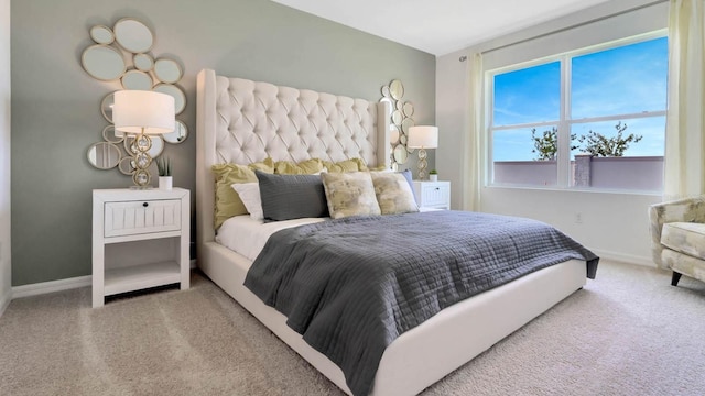 carpeted bedroom featuring baseboards