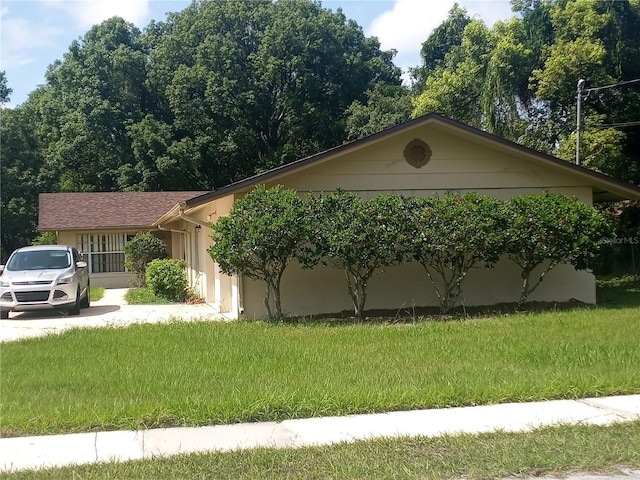 view of side of home featuring a lawn