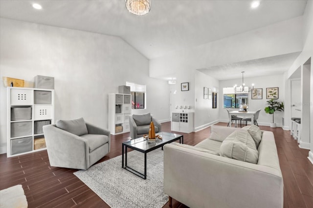 living room featuring vaulted ceiling, dark wood-type flooring, baseboards, and a notable chandelier