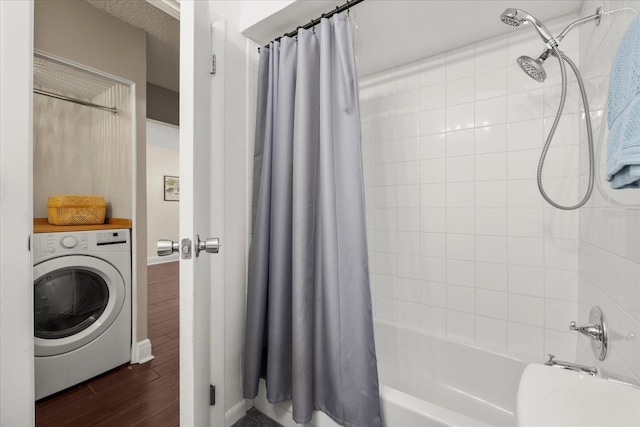 bathroom with washer / clothes dryer, shower / bath combo with shower curtain, and wood finished floors