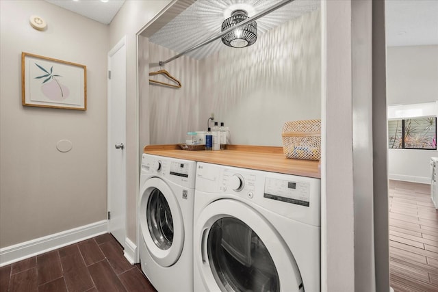 laundry area with washer and dryer, laundry area, baseboards, and wood tiled floor