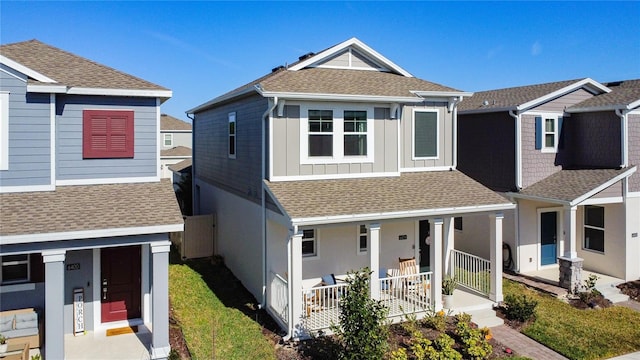 view of front of house featuring a shingled roof, a porch, and board and batten siding