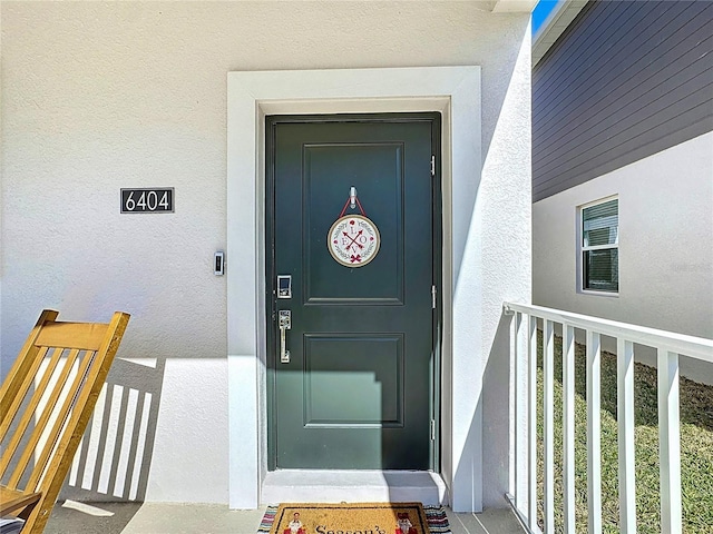 doorway to property with stucco siding