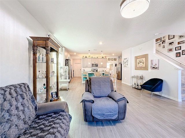 living area with light wood-style flooring and baseboards