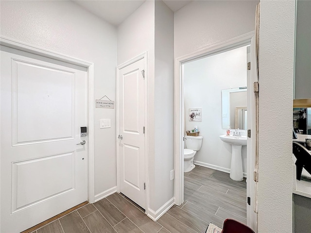 interior space featuring wood tiled floor and baseboards