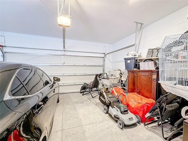 garage with concrete block wall and a garage door opener