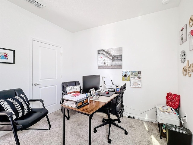 office space featuring visible vents and light carpet