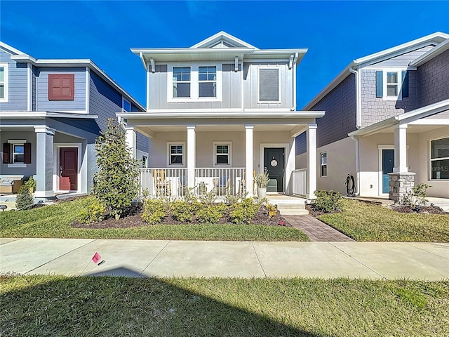 view of front of property with a porch, board and batten siding, and stucco siding