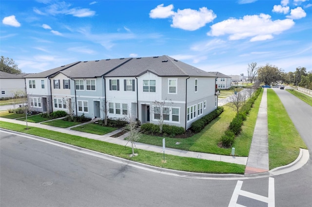 view of front of home featuring a residential view and a front lawn