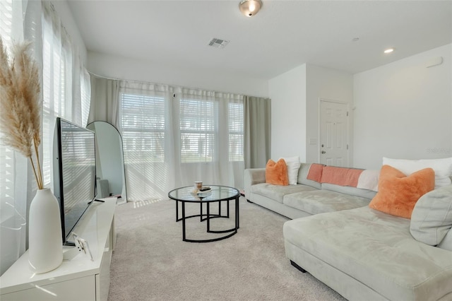 carpeted living room featuring visible vents