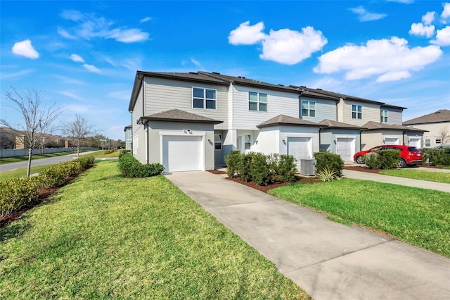 townhome / multi-family property featuring driveway, a garage, a residential view, and a front lawn